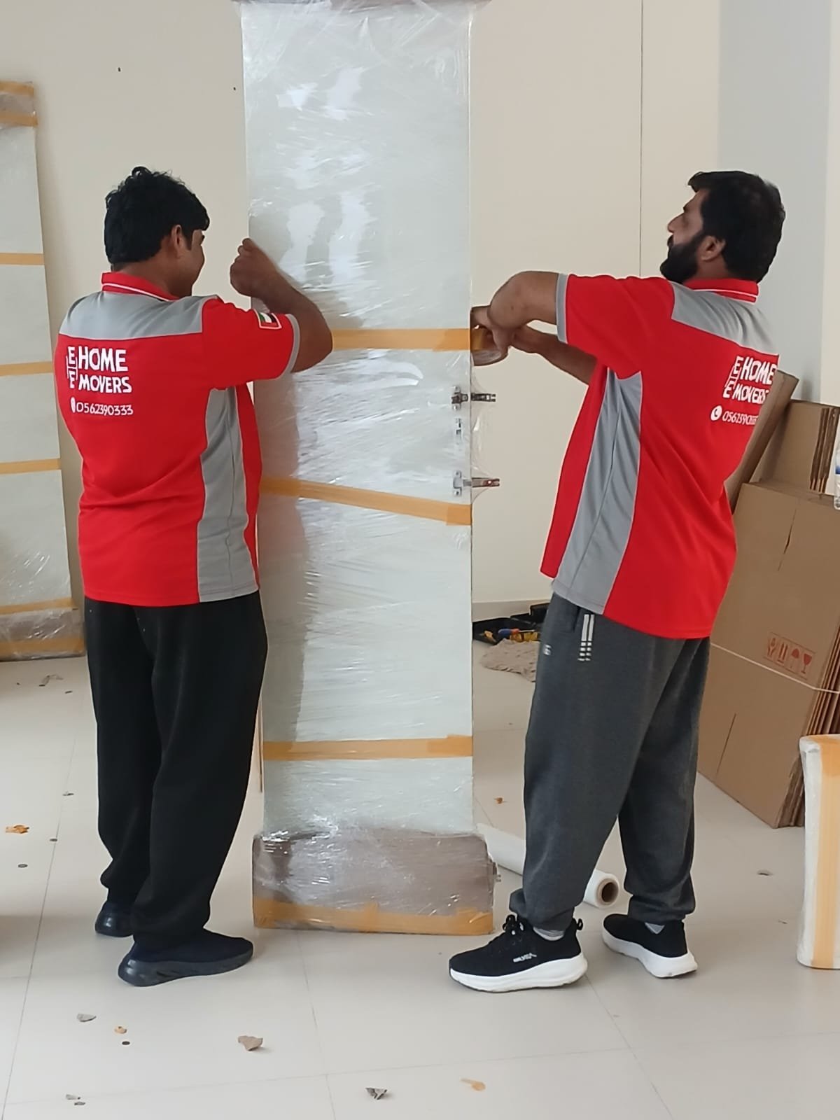 E-Home Movers team carefully wrapping and packing furniture in Dubai